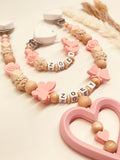 Schnullerkette und Kinderwagenkette Schmetterling in candy rosa-natur Holz, personalisiert