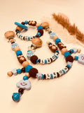 Schnullerkette, Kinderwagenkette Otter  personalisiert blau braun