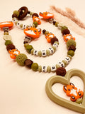 Schnullerkette, Kinderwagenkette und Greifring Fuchs grün braun, personalisiert