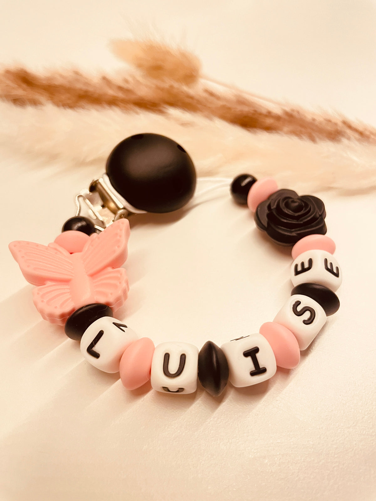 Schnullerkette Schmetterling mit Rose schwarz rosa, personalisiert mit Namen