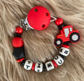 Schnullerkette Traktor rot schwarz, personalisiert mit Namen