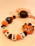 Abverkauf Schnullerkette Tiger schwarz orange